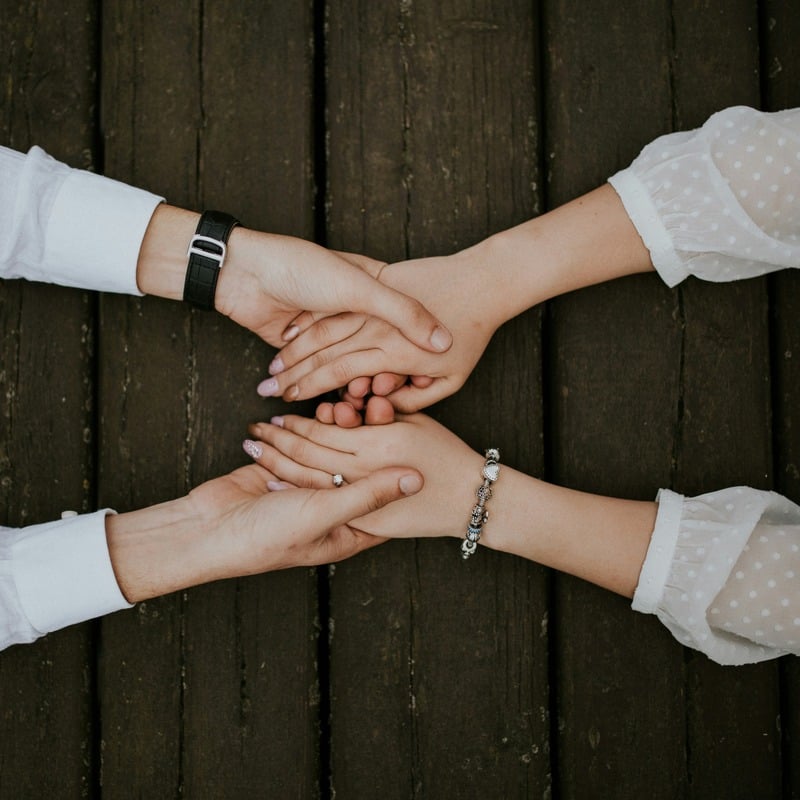 Hands clasped together in support at a CSN meet-up